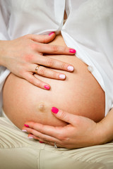 Fototapeta na wymiar future mother stroking her pregnant belly