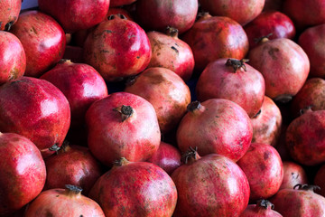 Colored red pomegranate fruit displayed on the market