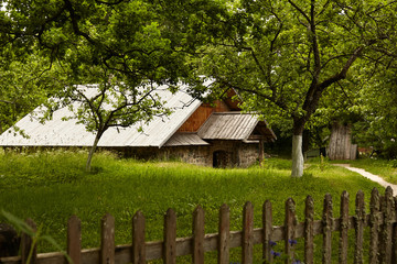 Old house in a garden. Historical agricultural estate. Old farm in the middle of a summer 