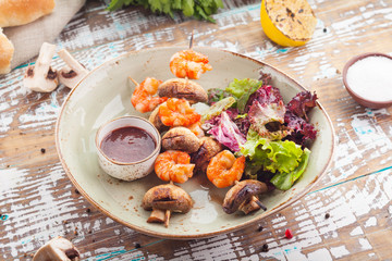 tiger shrimps with mushrooms and sauce tkemali 