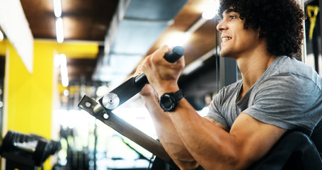 Fototapeta na wymiar Portrait of healthy fit man working out in gym