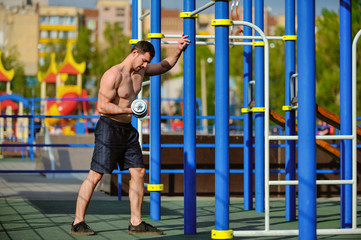 Intensive training of a young man on the sports ground