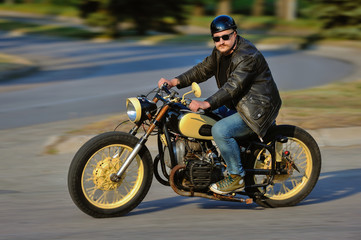 A view of a young man riding a motorcycle on an open road