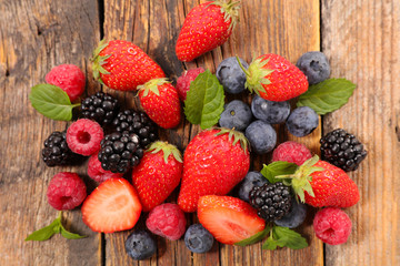 assorted of berries fruits on wood background