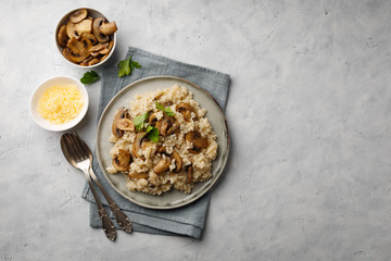 A dish of Italian cuisine - risotto from rice and mushrooms. Top view. Flat lay. Copy space.