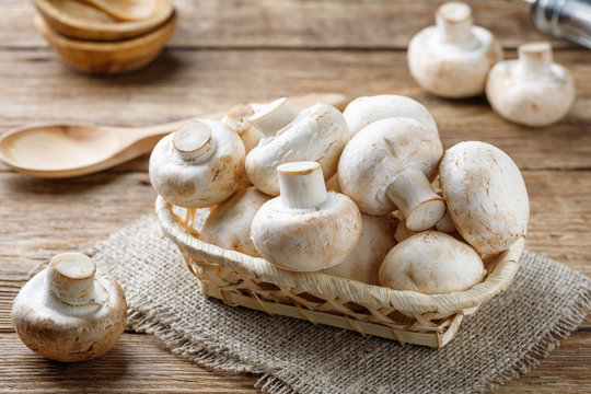 Fresh mushrooms champignon mushrooms on a wooden table.