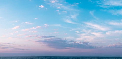 Sunrise clouds over the sea or ocean. Panorama wide banner image.