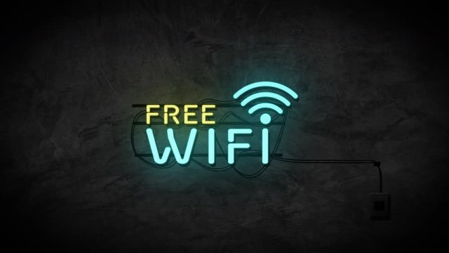 Free wifi neon sign on brick wall background. Business and service concept.