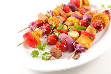 vegetarian barbecue skewer with corn, tomato, tofu and onion