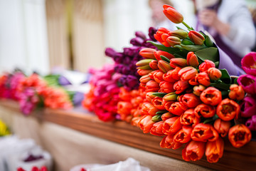 Fresh bouquets of tulips lying on the counter of the store
