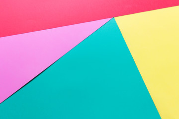 Layers of colored yellow pink mint green paper. Photo with copy blank space for text art presentation.