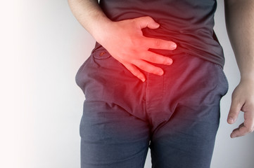 Man front view. Pain in the groin and bladder. The concept of pain in men as a result of...