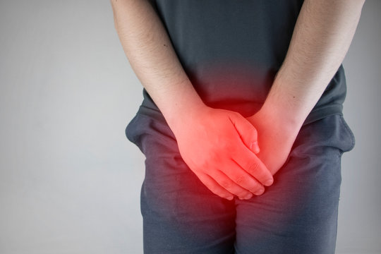 Man front view. Pain in the groin and bladder. The concept of pain in men as a result of prostatitis, inflammation of the bladder or genitourinary system. Frequent urination.