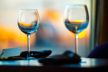 Empty wine glasses on the table against the background of the evening city
