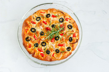 
Italian Focaccia Bread on White Background  Garnished with Rosemary Leaves, Directly Above Photo
