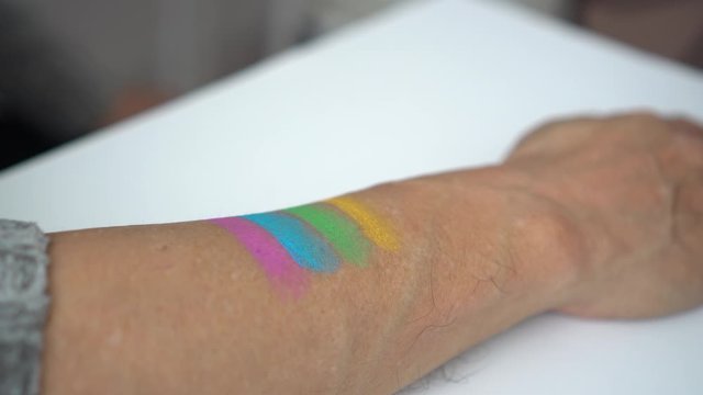Senior couple paint rainbox pride symbol to go support LGBTQ parade