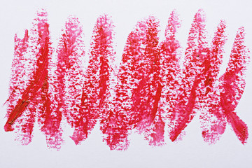 art strokes of scarlet red lipstick on white background