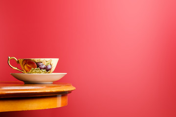 A cup of tea is on the table on a red background