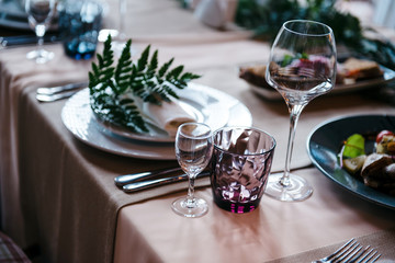 Tables set for an event party or wedding reception. luxury elegant table setting dinner in a restaurant. glasses and dishes.