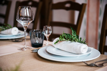 Tables set for an event party or wedding reception. luxury elegant table setting dinner in a restaurant. glasses and dishes.