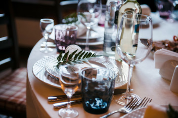 Tables set for an event party or wedding reception. luxury elegant table setting dinner in a restaurant. glasses and dishes.