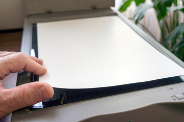 Hand of a man uploading a document for scanning