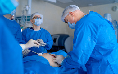 Process of surgery operation using medical equipment. Surgeon in operating room with surgery...