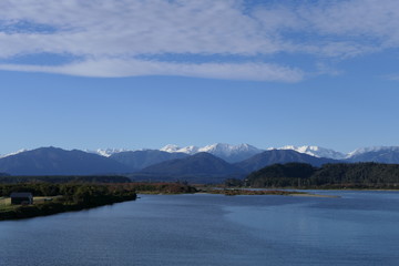 Fototapeta na wymiar Stream in New Zealand West Coast, Hokitika River with Southern Alps