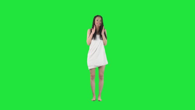 Slow motion of amazed surprised and excited young pretty woman jumping and winning. Full body pre keyed on green screen chroma key background