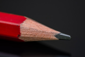 Obraz premium Red pencil in high resolution isolated on black background ,Isolated graphite pencil