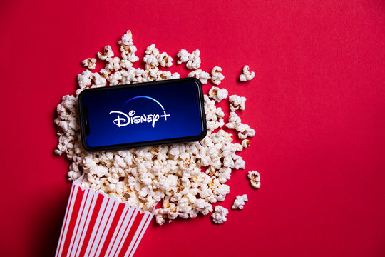 LONDON, UK - MAY 14 2020: Disney plus logo on a smartphone with popcorn