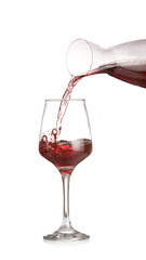Pouring of wine from decanter into glass on white background