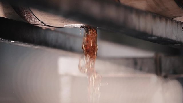 Bourbon Whiskey dumping out of barrel in slow motion