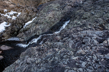 major stone texture and background. Quarry overgrown with moss