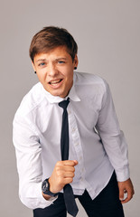 a young man pulls himself by his tie, he is tired of office work