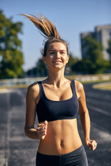 Athletic woman on track starting to run