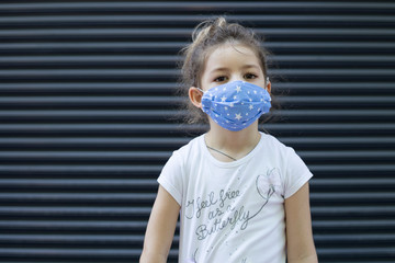 child with protective mask at the streets