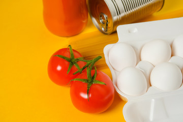 Food donations on a yellow background. Social assistance. Copy space.