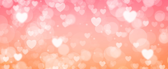 Glowing  pink and orange bokeh background.  Spring concept.  Blurred bokeh circles and hearth shapes.