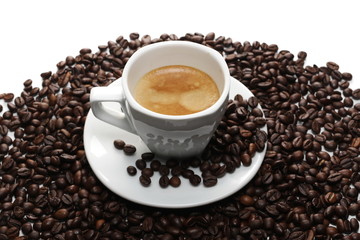 Cup of coffee and saucer with beans isolated on white background