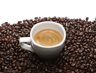 Cup of coffee with beans isolated on white background