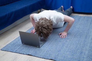 Online fitness classes at home. Using a laptop for classes.
