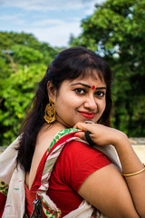 Fototapeta premium Beautiful South East Asian lady in white and red traditional dress with light background