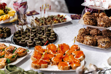 Food on the table, red caviar sandwiches