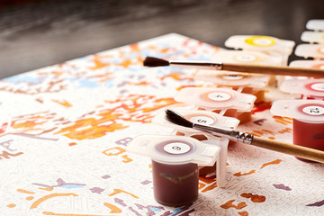 Brushes, canvas and paints set for painting by numbers. Learn how to paint and draw pictures from home. Studying equipment for children and adults
