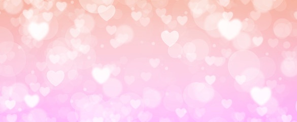 Glowing soft orange and pink bokeh background. Spring concept. Blurred bokeh circles and hearth shapes.