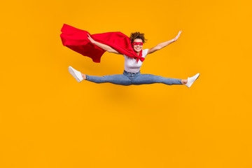 Full length body size view of her she nice attractive lovely funky fit slim cheerful cheery girl jumping wearing cape doing twine isolated bright vivid shine vibrant yellow color background © deagreez