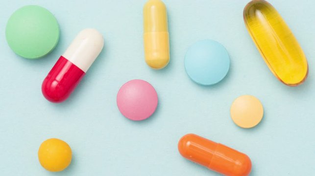Stop motion animation of colorful pills on blue