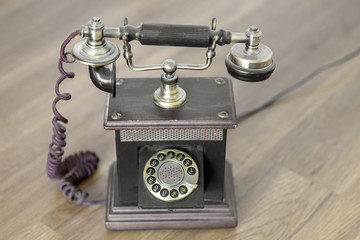 Old vintage telephone with handset on cradle