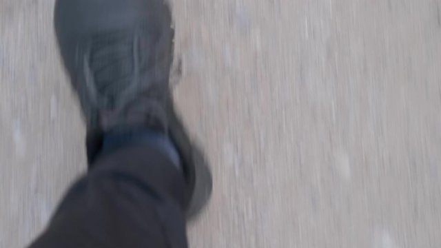 walking on a forest road from the perspective of your own eyes on shoes and feet slow motion, concept of healthy lifestyle and exercise